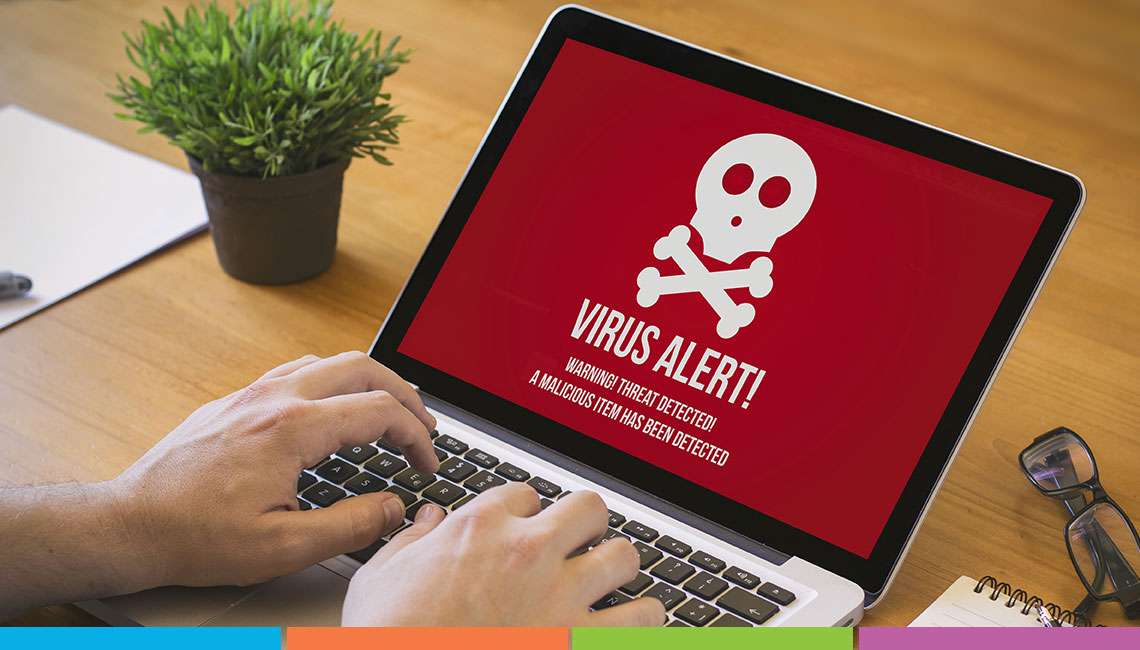 virus alert with skull icon on laptop screen