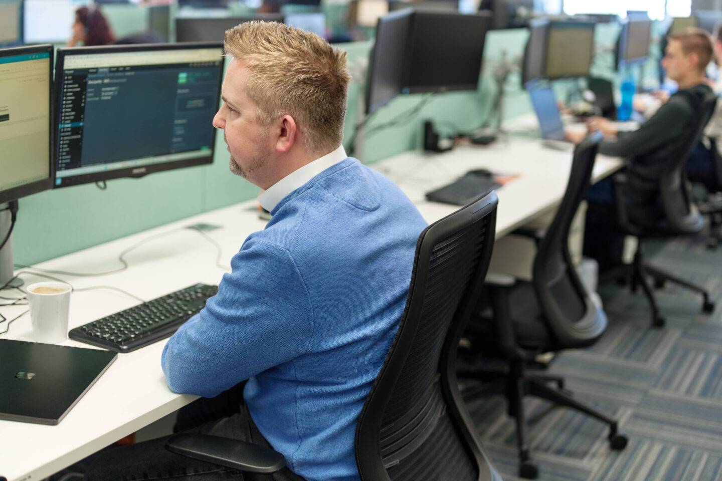 Man sat at desk screen