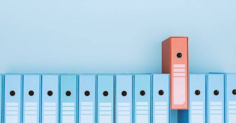 Orange folder among blue folders