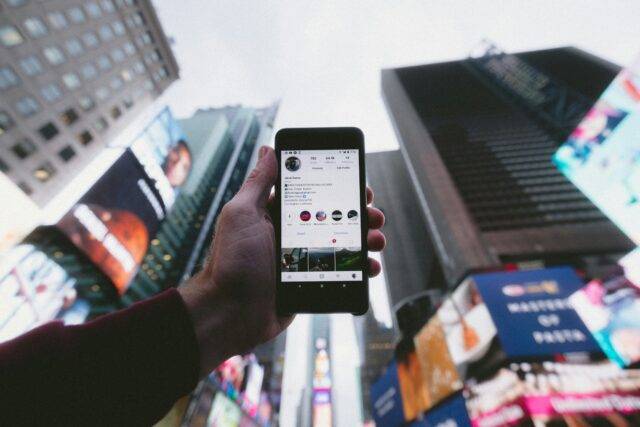Man holding phone in city