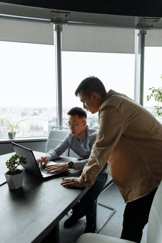 Two people looking at a laptop