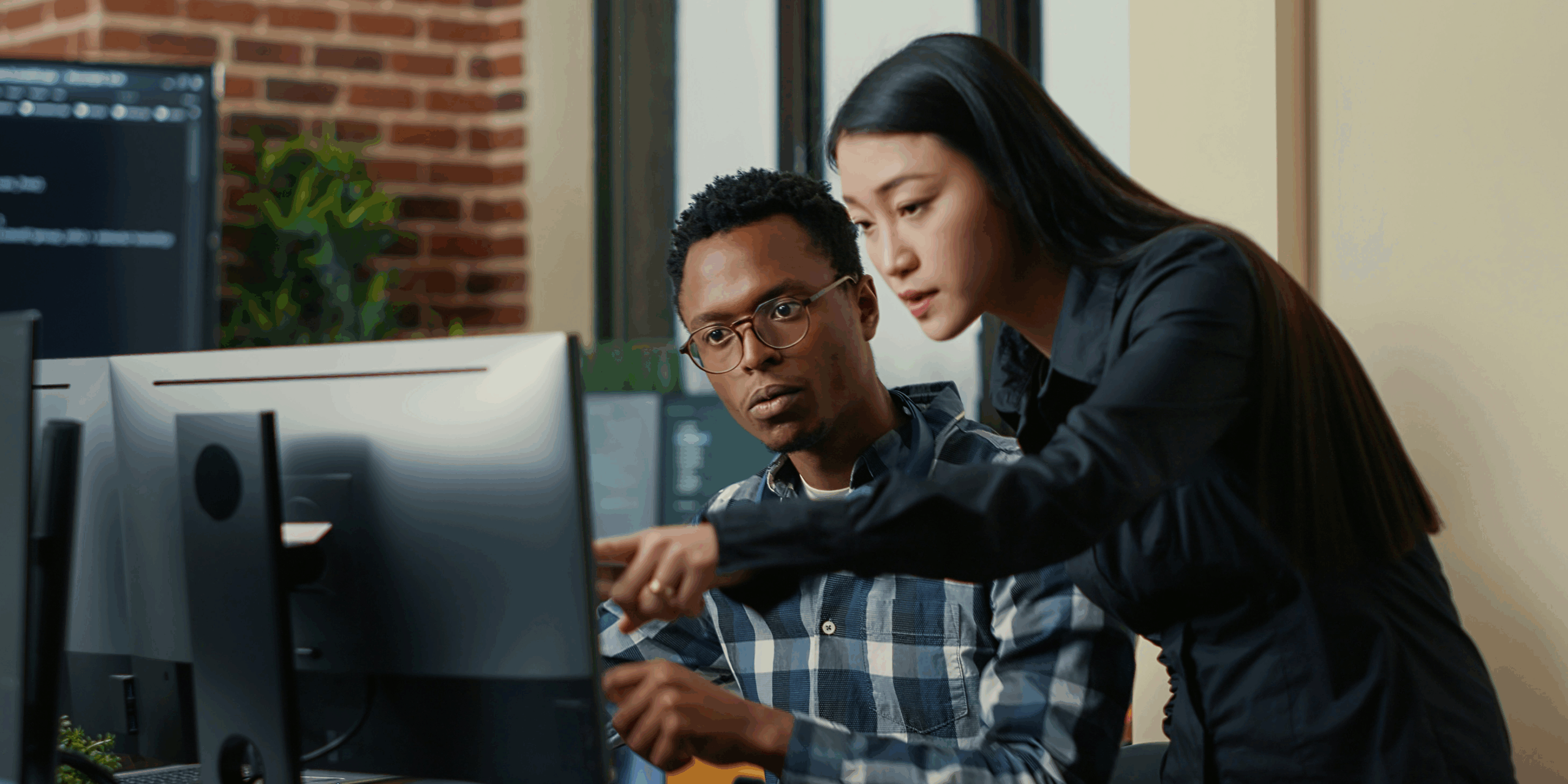 Two people looking at a computer screen
