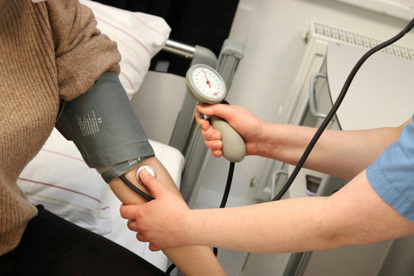 Nurse takes patient's blood pressure