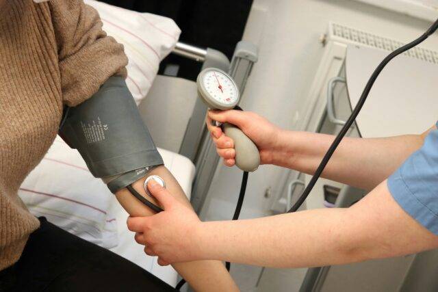 Nurse takes patient's blood pressure