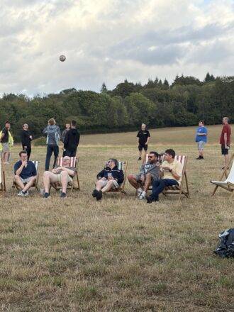 Team members sitting and standing on the field