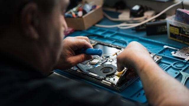 Man fixing laptop