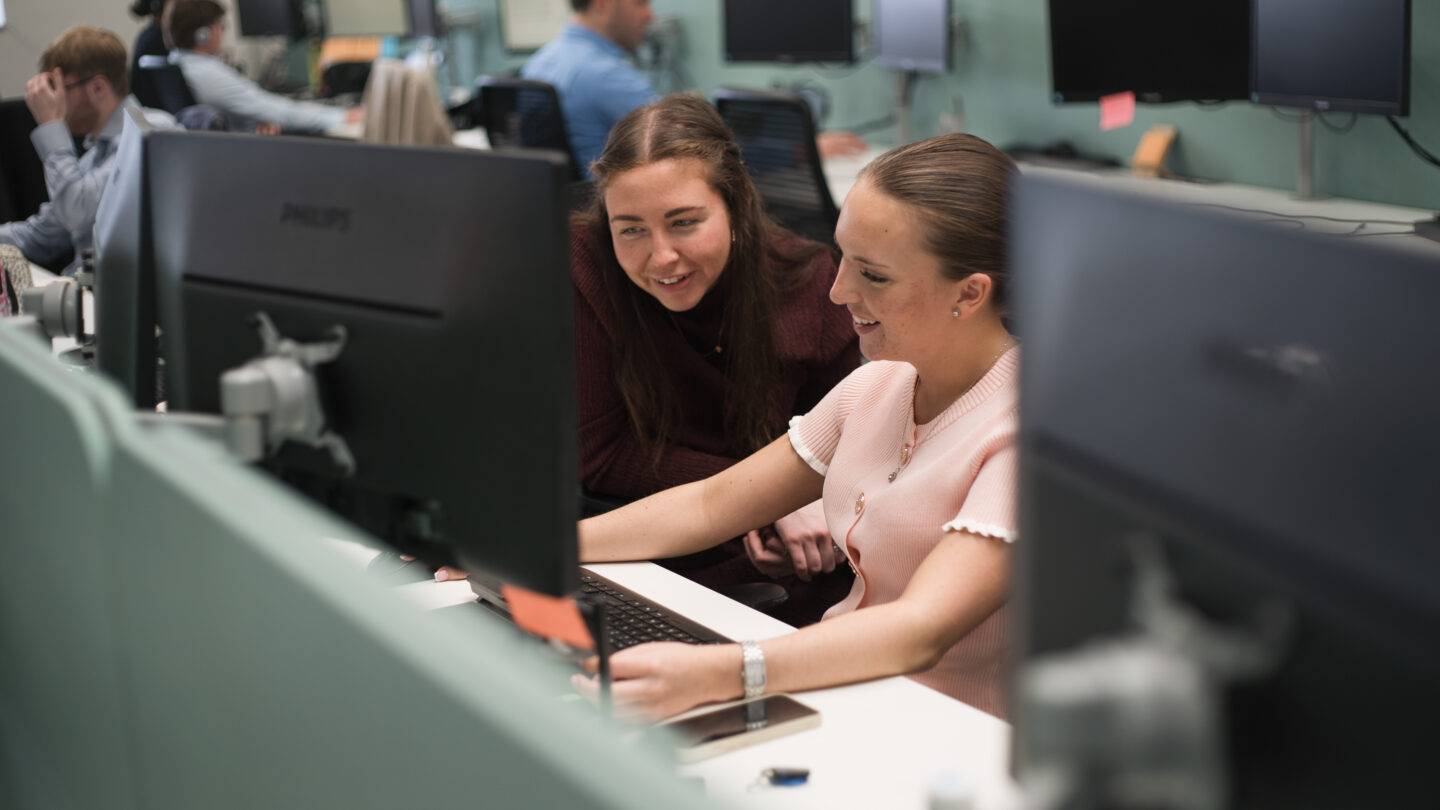 girls smiling at a laptop