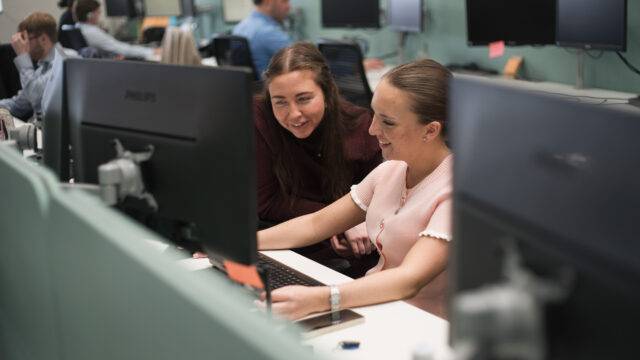 girls smiling at a laptop