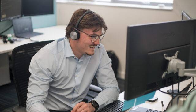 Man smiling at laptop screen