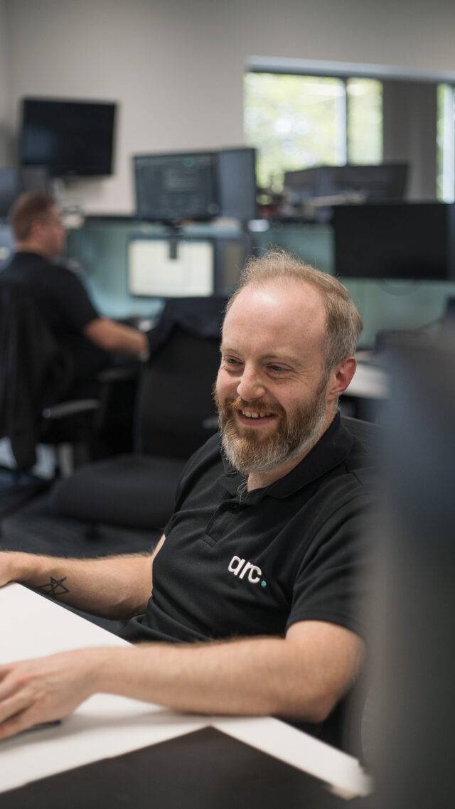 Arc employee at laptop