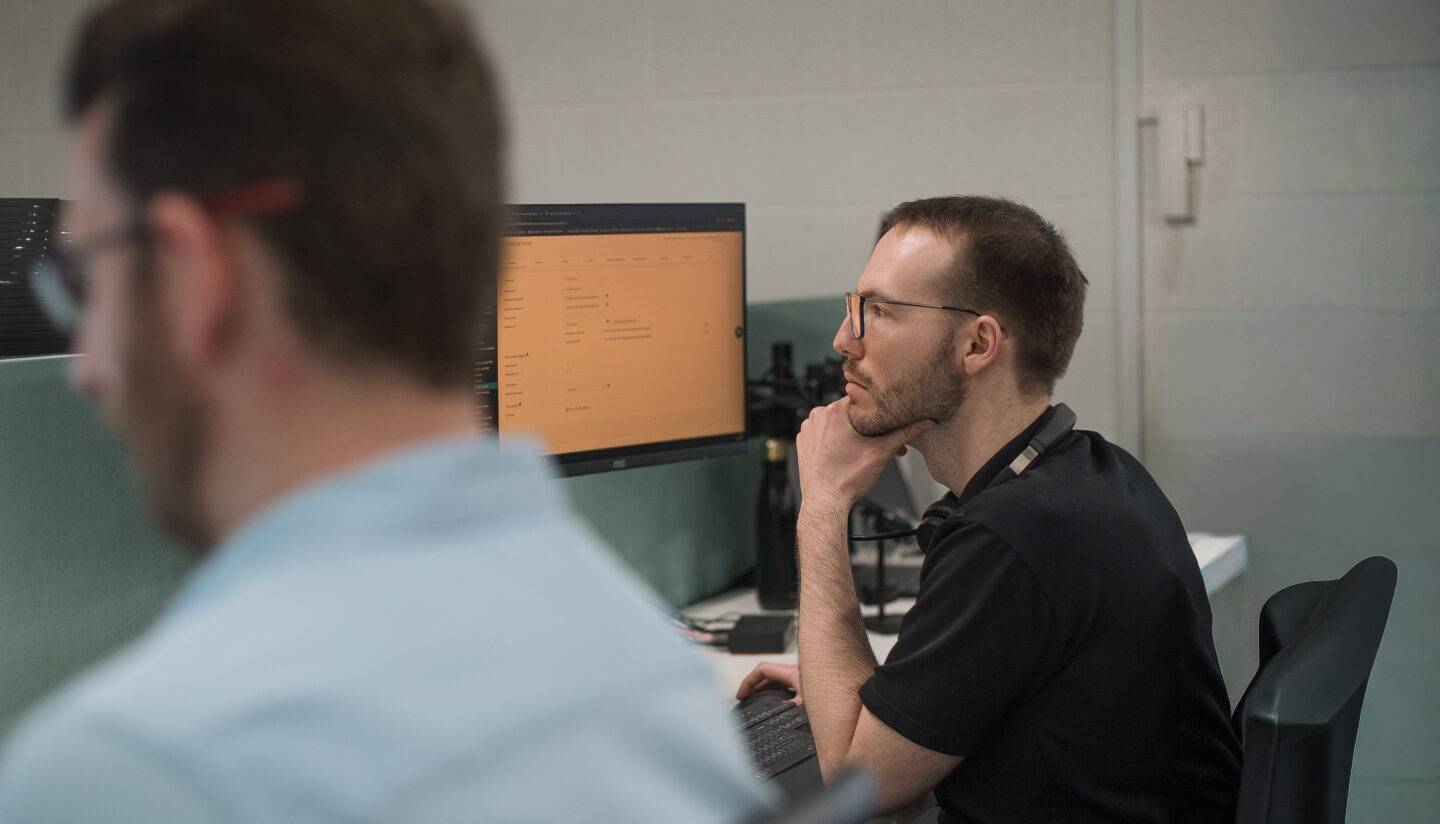 Arc employees looking at laptops