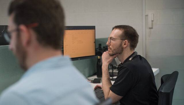 Arc employees looking at laptops